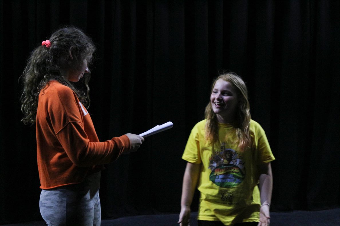 Two girls rehearse a scene in a script